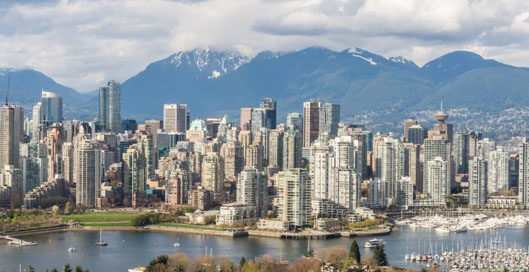 Vancouver British Columbia skyline with harbor and mountains